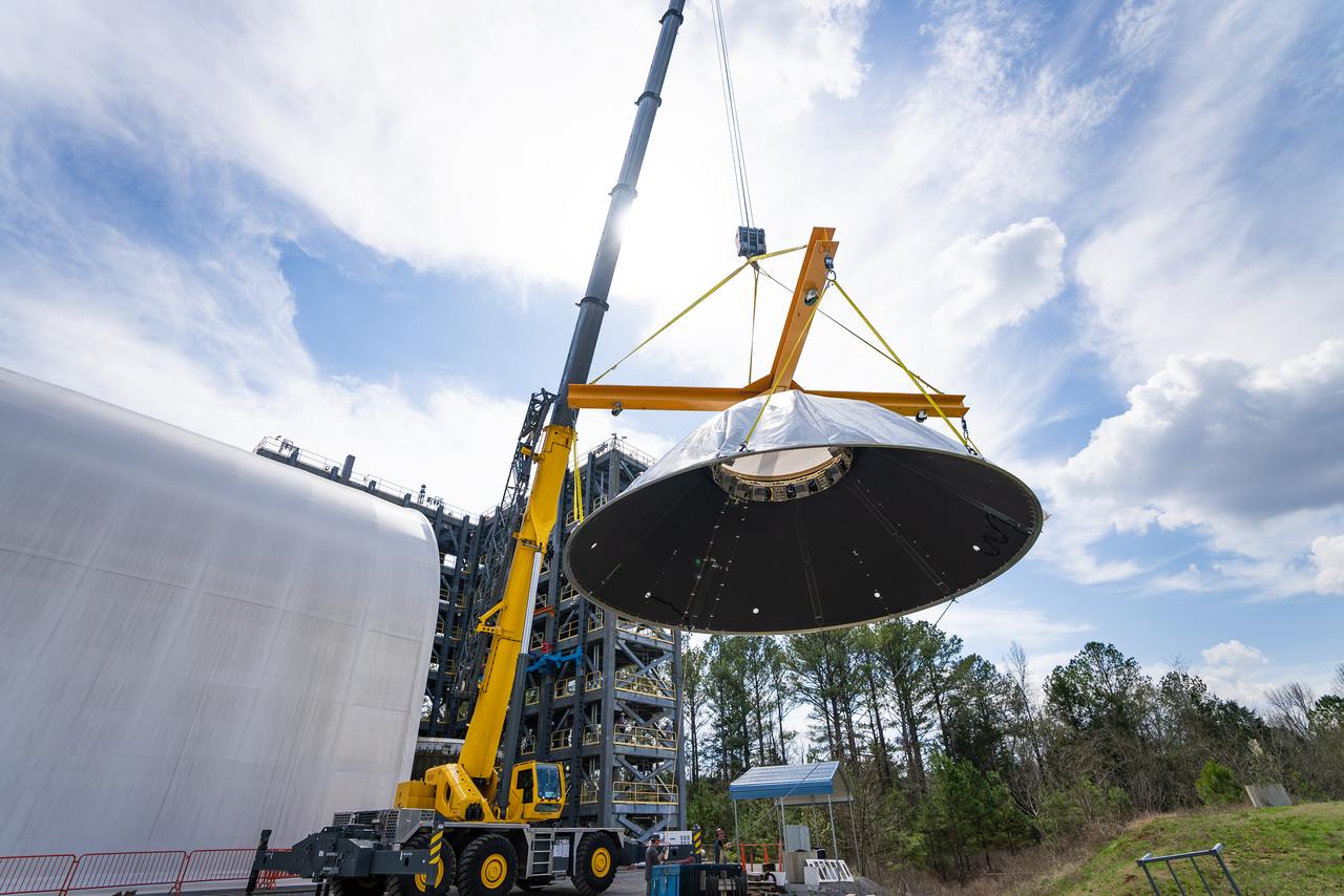 These photos and videos show how crews at NASA’s Marshall Space Flight Center in Huntsville, Alabama, moved and installed the payload adapter that will be used in the Block 1B configuration of the SLS (Space Launch System) rocket from Building 4708, where it was manufactured, into Structural Test Stand 4697 at NASA’s Marshall Space Flight Center on March 13. Teams at Marshall will begin structural testing the engineering development unit of the payload adapter – an exact replica of the flight version of the hardware – this spring. The cone-shaped payload adapter is about 8.5 feet tall and features two metal rings and eight composite panels. The adapter, which will debut on NASA’s Artemis IV mission, is an evolution from the Orion stage adapter used in the Block 1 configuration of the first three Artemis missions. It will be housed inside the universal stage adapter atop the rocket’s more powerful in-space stage, called the exploration upper stage. The payload adapter, like the launch vehicle stage adapter and the Orion stage adapter, is fully manufactured and tested at Marshall, which manages the SLS Program. NASA is working to land the first woman, first person of color, and its first international partner astronaut on the Moon under Artemis. SLS is part of NASA’s backbone for deep space exploration, along with the Orion spacecraft and Gateway in orbit around the Moon and commercial human landing systems, next-generational spacesuits, and rovers on the lunar surface. SLS is the only rocket that can send Orion, astronauts, and supplies to the Moon in a single launch.